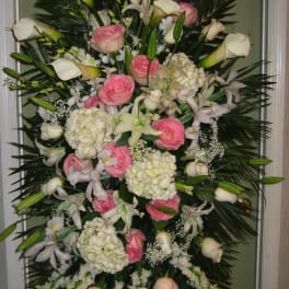 Tall standing floral spray with pink roses, white calla lilies, and white hydrangeas