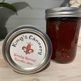 Two jars of smoky spiced tomato jam on a countertop