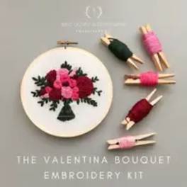 Embroidery kit with a floral bouquet design and small wrapped thread bundles