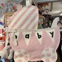 Pink fabric baby carriage wall hanging with polka dots and bunting