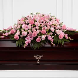 Pink floral casket spray with roses and lilies