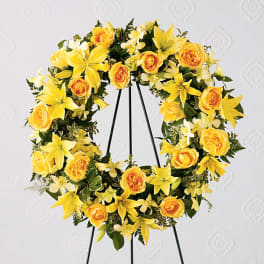 Yellow floral wreath on a black stand