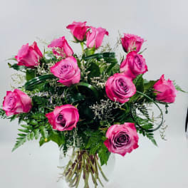 Pink roses arranged in a clear glass vase