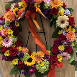 Large floral wreath with roses, gerbera daisies, and bird-of-paradise flowers