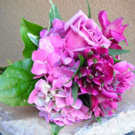 Pink rose and hydrangea bouquet with green leaves