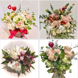 Four romantic arrangements with pink roses, hydrangeas, and accent blooms in vases with red heart picks.