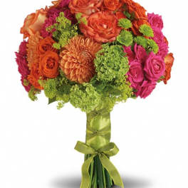 Bright bouquet of orange, pink, and green flowers tied with a ribbon