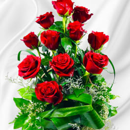 Tall basket arrangement of red roses with greenery