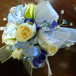 Small bouquet of cream and blue flowers with ribbon and crystal picks