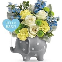 Blue, yellow, and white flowers in a gray elephant vase with a "Hello Baby!" sign