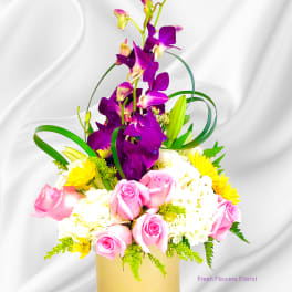 Pink roses and white flowers in a gold vase with tall purple orchids