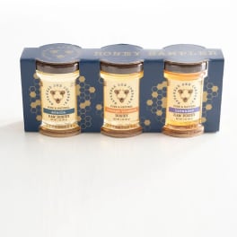 Three jars of honey in a blue sampler box