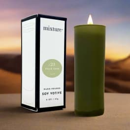 Green soy votive candle beside its box