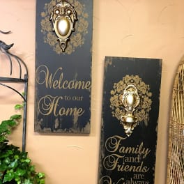 Two decorative wall plaques with gold accents and welcome text