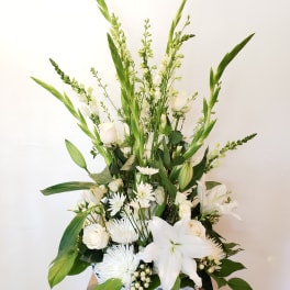 White floral arrangement in a white wicker basket