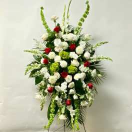 Standing floral spray with red and white roses and green accents