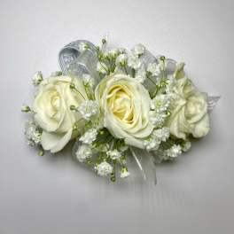 White rose corsage with baby's breath and silver ribbon