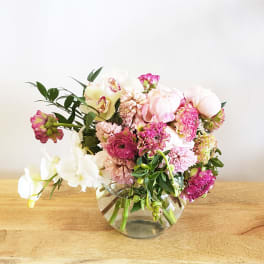 Pink and white floral arrangement in a clear glass vase