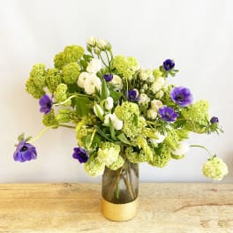 Bouquet of white and purple flowers in a glass vase