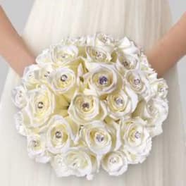 Bride holding a round bouquet of white roses