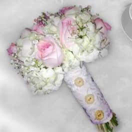 Pink and white rose bouquet wrapped in lavender paper