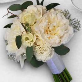 Cream-white bridal bouquet with roses and peonies wrapped in lavender ribbon