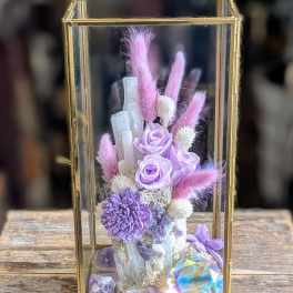 Lavender roses and purple flowers in a gold glass lantern