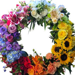 Colorful floral wreath with roses, lilies, and sunflowers