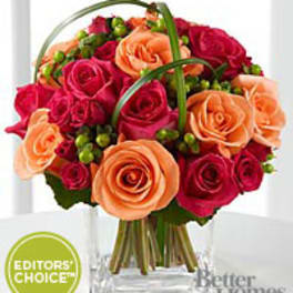 Bouquet of pink and peach roses in a clear vase