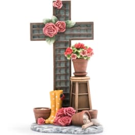Decorative cross with pink roses and a potted flower arrangement