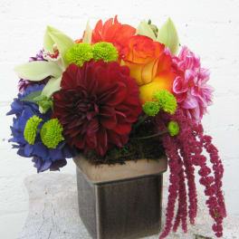 Colorful mixed flower arrangement in a square vase