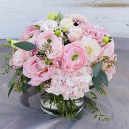 Pink and white bouquet in a clear glass vase