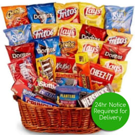 Gift basket filled with assorted chips, candy, and snacks with a green delivery notice badge