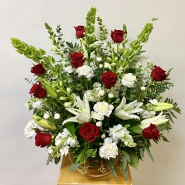 Red roses and white lilies in a basket arrangement