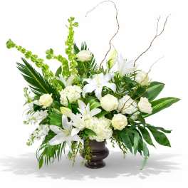 White lilies and cream roses arranged in a dark vase