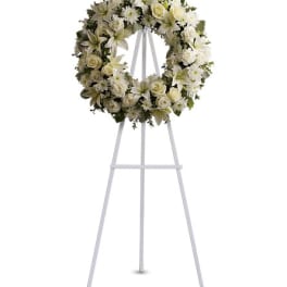 White floral wreath on a standing easel