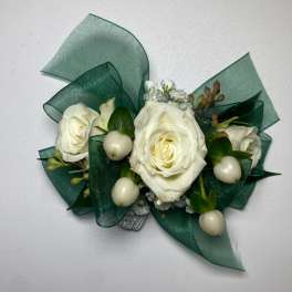 White rose corsage with green ribbon and white berries