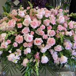 Large arrangement of pale pink roses and carnations