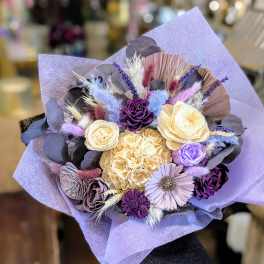 Lavender bouquet with cream and purple flowers wrapped in lilac paper