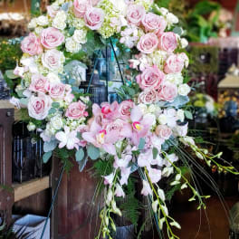 Large pink and white floral wreath on an easel