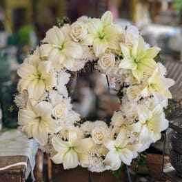 White floral wreath with lilies and roses