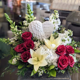 Sympathy bouquet with red roses, white lilies, and a heart memorial plaque