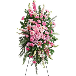 Tall pink floral standing spray on an easel