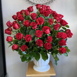 Bouquet of red roses in a white vase