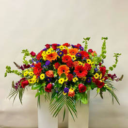 Large mixed bouquet of red, orange, yellow, and purple flowers