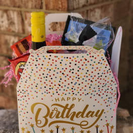 Birthday gift basket with wine, snacks, and a decorated box