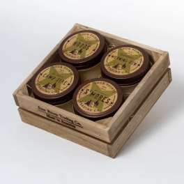 Wooden crate holding four round scented candles