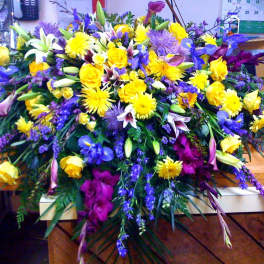 Large mixed floral spray with yellow, purple, and white blooms