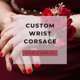 Red rose wrist corsage on a hand