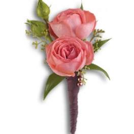 Pink rose boutonniere with green accents and a purple wrapped stem